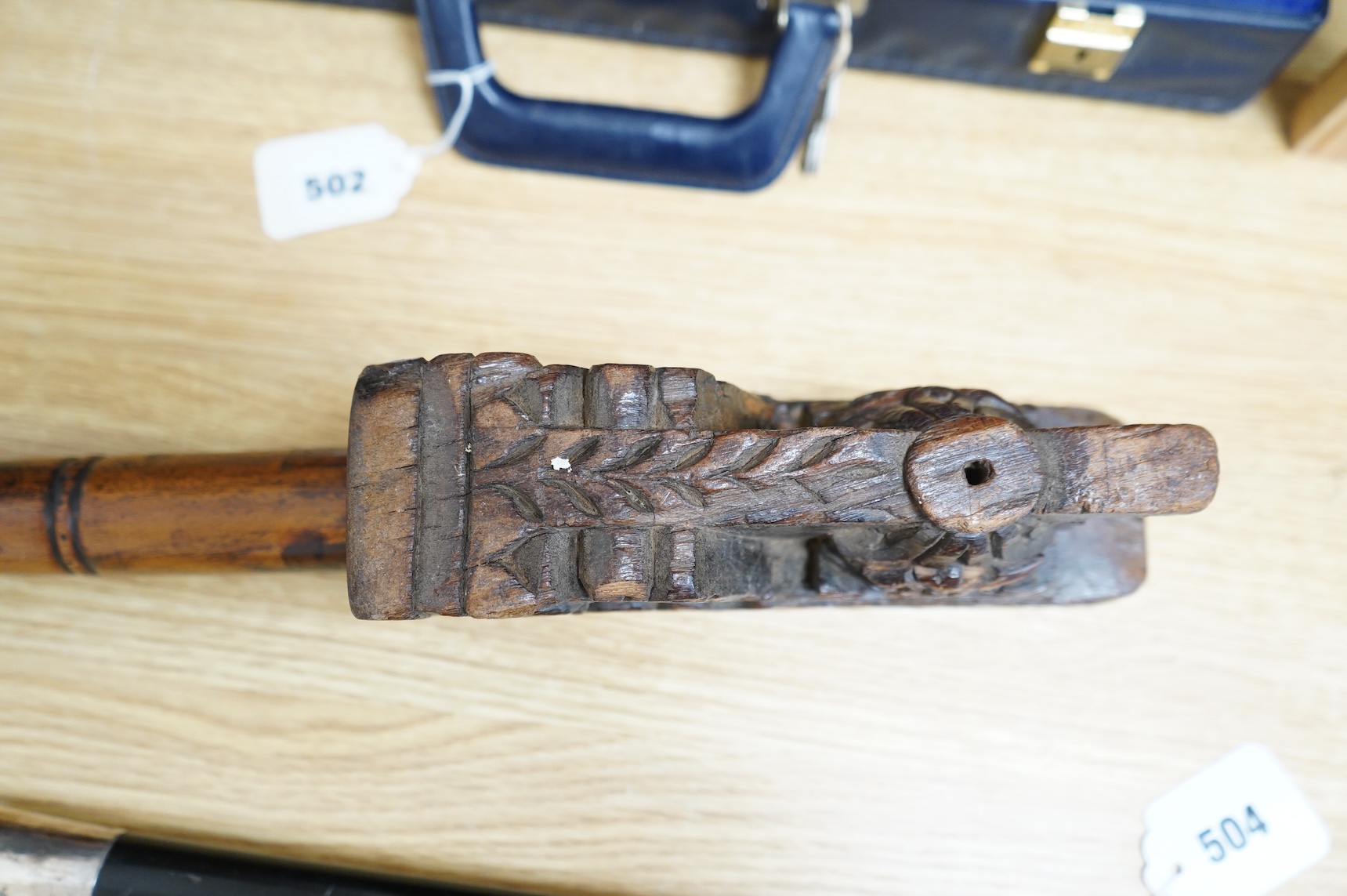 An 18th / 19th century Indian carved wood oil pourer, 43cm